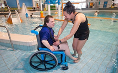 Chrystal tries out the new wet wheelchair design at Pioneer Recreation and Sport Centre with her carer Jess.