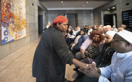 Aboriginal artist Nyunmiti Burton shakes hands with Lateef Zikrullah Alabi.