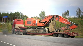 overweight truck towing a digger